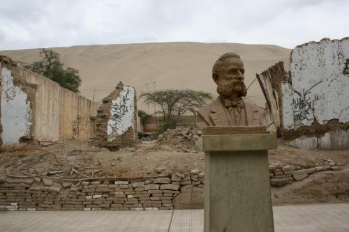 Statue of Francisco Flores Chinarro with derelict building in background